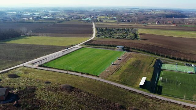 Soccer field in Ub Serbia showcases green landscape and neighboring sports facilities