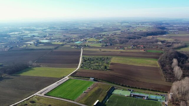 Scenic aerial view of Ub, Serbia showcasing rural landscape and sports field in winter
