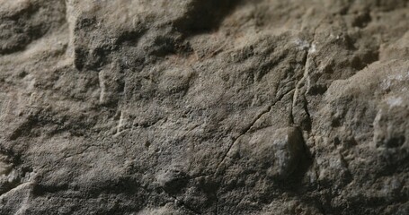 Close-up of weathered sandstone with soft ridges and dramatic lighting