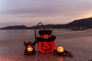 Concept: Halloween beach and ocean background with spider, witch and ghost pumpkin. Dark, scary tone.