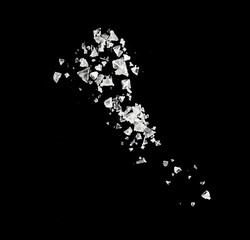 Close-up of falling salt crystals isolated on black as texture
