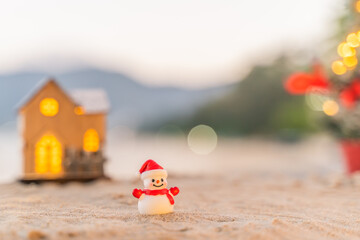 Santa Claus Doll Cute and Christmas Tree House Relaxing on the Beach. Merry Christmas Holiday. Bright Background. Patong Beach, Phuket, Thailand.