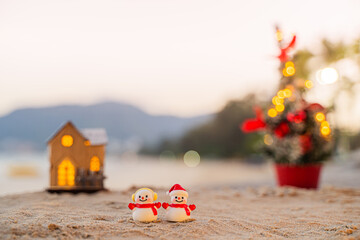 Santa Claus Doll Cute and Christmas Tree House Relaxing on the Beach. Merry Christmas Holiday. Bright Background. Patong Beach, Phuket, Thailand.