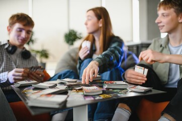Friends playing board game at home, having fun together