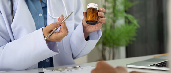 Health and Wellness. Doctor explaining medication while holding a health summary.