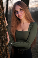 smiling portrait at sunset next to a tree