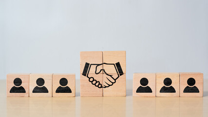 Hand shaking print screen on wooden block cube between human icon for business deal and agreement...