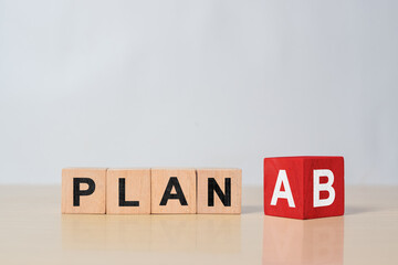 PLAN A change to PLAN B text on wooden blocks. Symbol of business strategy, adaptation, project...