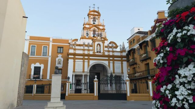 Architectural detail of the Church of La Macarena, featuring its iconic white and ochre colors and ornamental elements. An evocative clip for religious documentaries or historical videos