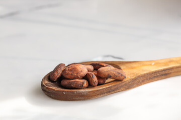 Cacao beans on rustic spoon