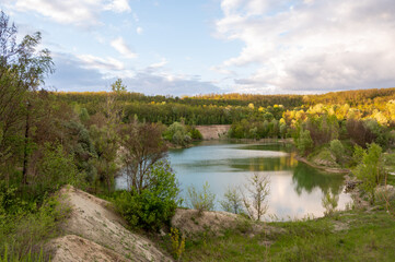 An abandoned white clay quarry. A lake in the mountains