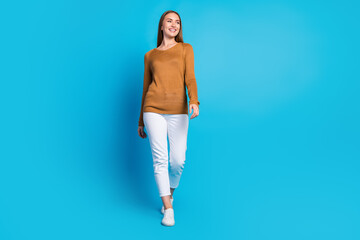 Bright and cheerful young woman in stylish casual wear smiling confidently in front of a vibrant...
