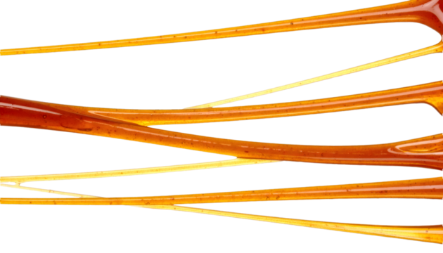 Molasses threads stretching in mid air with a transparent background