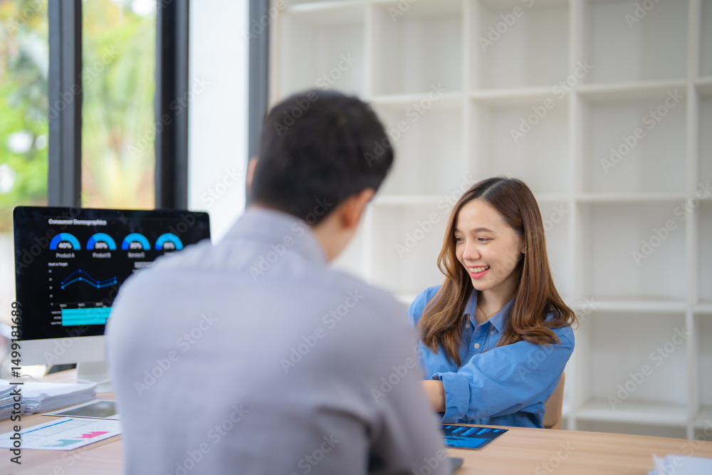 Aufkleber two asian business professionals engaging in a discussion about data analysis presented on a compute