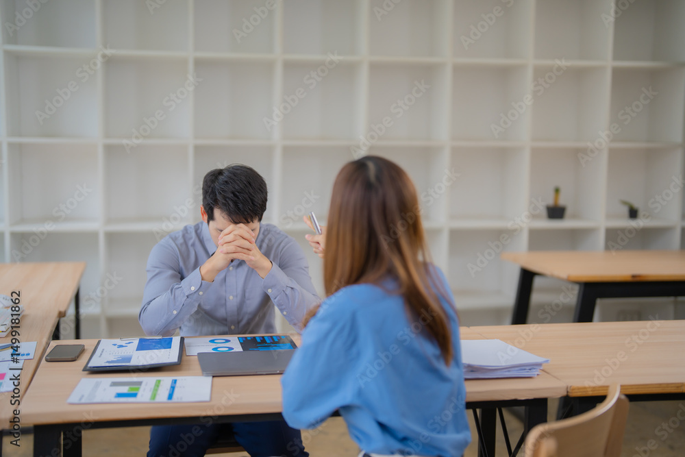 Aufkleber stressed businessman covering face with hands while business partner is explaining marketing strateg