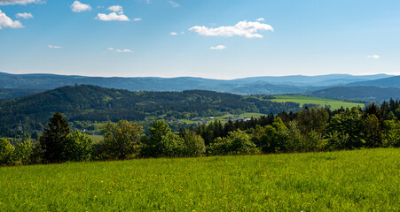 Fototapeta premium Ridge hiking trail from Javornik to Jested with scenic views into valleys and distant Jizera Mountains. Sunny summer day, peaceful nature and beautiful Czech landscape