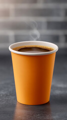 Hot black coffee in an unmarked orange cup made of kraft cardboard, on a dark, smooth tabletop