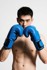 arafed man in blue boxing gloves posing for a picture