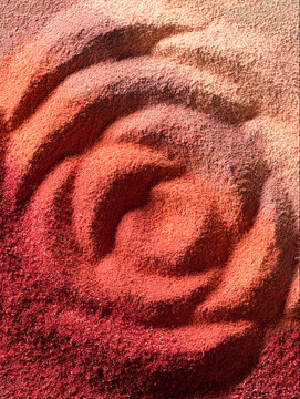 Rose shaped texture of red, bronze; brown and beige eye shadow. Cosmetic product swatch