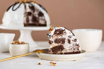 Piece of Pancho Cake. Homemade biscuit cake with sour cream, pineapple and cup of coffee on a white table. Vegan dessert. Sugar, lactose and gluten free.