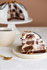 Piece of vegan Pancho cake with pineapple and sour cream topped with chocolate biscuit and walnut and cup of chicory drink. Sugar, lactose and gluten free. Vertical orientation.