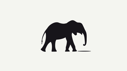 Fototapeta premium The image presents a minimalist silhouette of an elephant rendered in solid black against a stark white background. The silhouette is a two-dimensional representation, lacking texture or detail