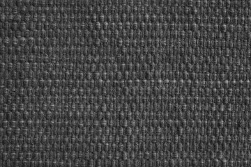 Texture of black natural fabric with large weaving. Surface, structure of upholstery or carpet material, cloth background close up.