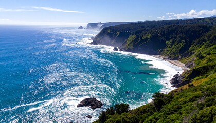 Aerial view of a rugged coastline featuring turquoise ocean waves crashing against cliffs and a lush green forest