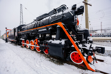 Old train in railway station in winter day