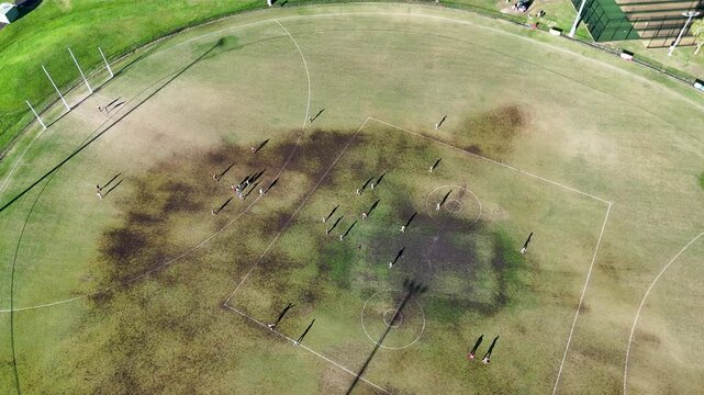 Aerial View of AFL Game at Sunset