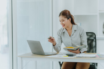 Asian Woman Working at Desk with Laptop