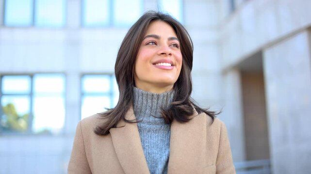 Confident businesswoman smiling and looking up in a slow motion montage, expressing hope and optimism for future success