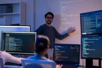 Asian software engineer or programmer team working late in development office,problem solving or...