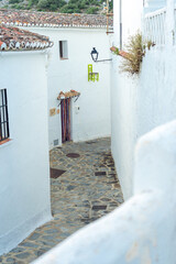 Street of the beautiful white village of Parauta in the Ronda mountains at sunset. Malaga province, Andalucia, Spain.