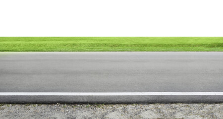Asphalt road leading to green grass field