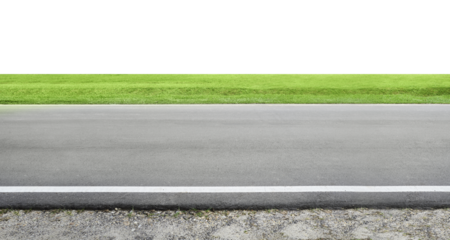 Asphalt road leading to green grass field