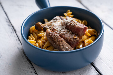 steak and mushroom pasta in alfredo sauce