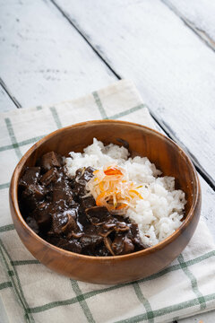 pork belly with pork ears in vinegar pork blood stew also known as dinuguan topped with pickled vegetables; a local delicacy in the Philippines