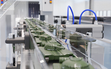 Miniature tanks move along an automated assembly line in a modern factory, symbolizing industrial military production and defense automation.