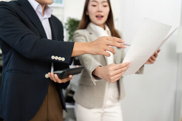 Business Collaboration and Strategy. Professionals discussing project documents in modern office.