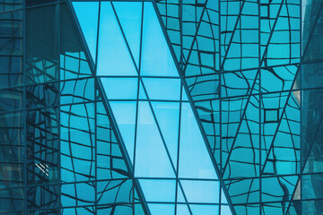 Unique architectural design showcases blue glass reflections on modern building facade in urban...