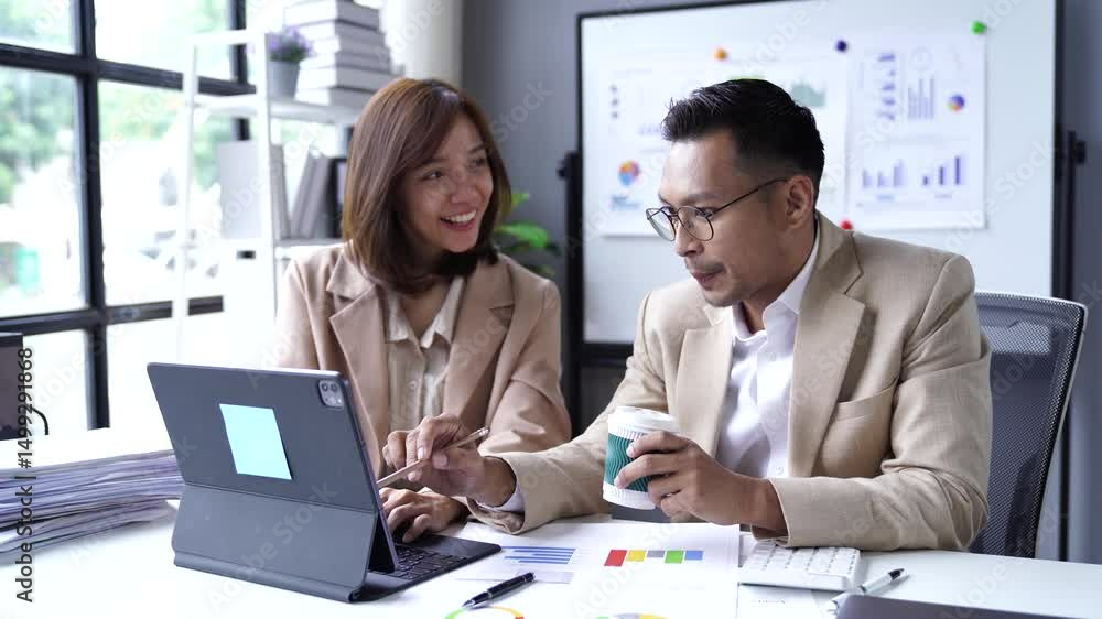 Aufkleber professionals discussing project details collaboratively at a modern office desk, using a laptop and