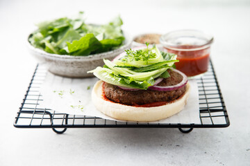 Homemade beef burger with cucumber salad