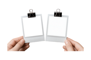 Two blank photo frames held by hands.
