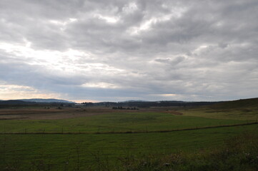 countryside landscape with cloudy sky while in motion