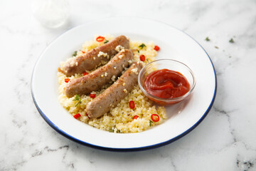 Grilled sausages with couscous and tomato sauce
