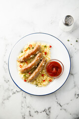 Grilled sausages with couscous and tomato sauce