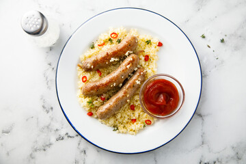 Grilled sausages with couscous and tomato sauce