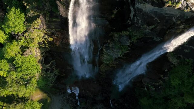Aerial View Of Acquafraggia Waterfalls Cascading Down Rugged Cliffs In Lombardy, Italy. topdown drone shot