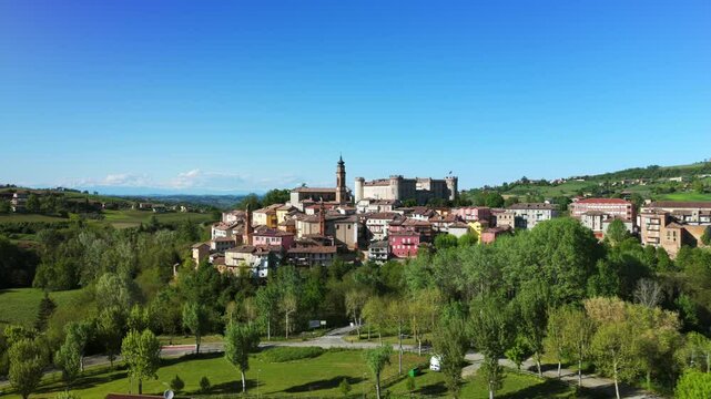 Picturesque Italian Village Costigliole d'Asti Against Clear Blue Sky In Province Of Asti, Piedmont, Italy. drone sideways shot